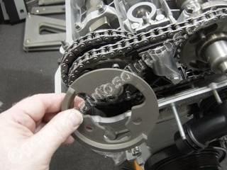 #25 Locate the exhaust sprocket spring washer. Note the side marked "F" faces outward.