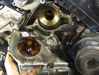 This is the reason we loosened the power steering pump way back in Step 6. Pry the pump away from its gasket.
