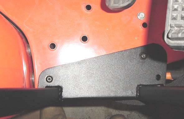 Being careful not to damage the Expand-a-foam that will seal against the fender contour. For best results, align the side frame over the fender and lower it into position.