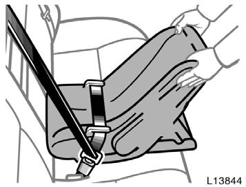 While pressing the infant seat firmly against the seat cushion and seatback, let the shoulder