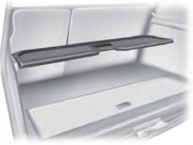 Pull up and pivot the shelf over the channels on the side trim panels and snap the shelf ends in the channels.