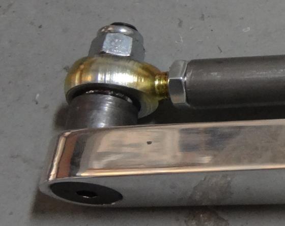 The flat head bolt goes in from the outside to match the taper of the countersunk end of the aluminum arm.