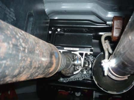 If equipped with a 2 piece driveline, remove the bolts holding the carrier bearing to the frame.