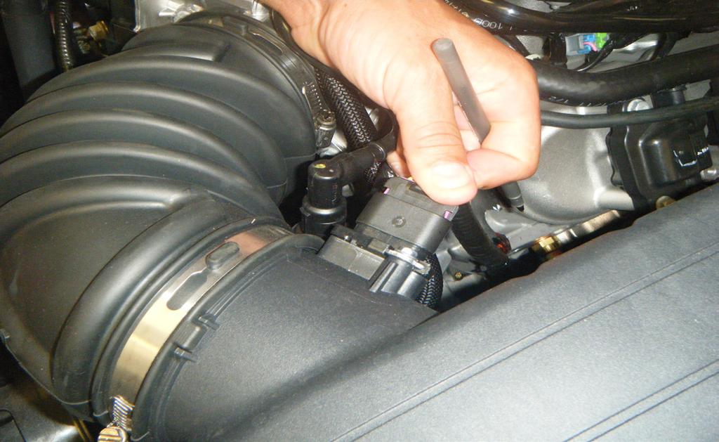 2. Remove the engine cover by pulling the front of of the cover up and away from the
