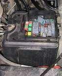 To connect the positive lead, route the Red (+) wire to the fuse panel located under the hood on the driver s side wheel house.