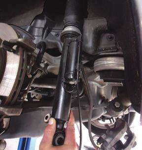 15. PULL DOWN ON THE LOWER CONTROL ARM AND REMOVE THE AIR STRUT FROM THE