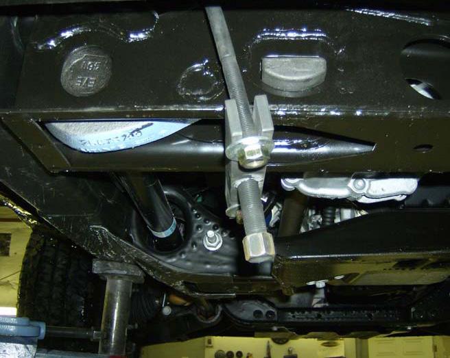 Carefully remove the stock torsion bar bolt and block.