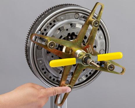 Position the pressure plate on the flywheel; align dowels and bolt holes where necessary.