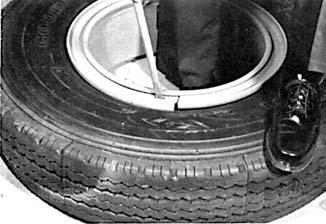 complete deflation). 2. Loosen the tire bead from the side ring by using a duck bill hammer or other bead breaking tool.