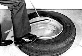 Force the tire bead into the well opposite of the tire irons with your feet, then pull both irons toward the center of the rim, prying part of the