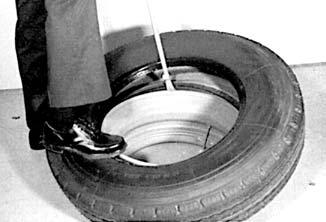 FOR TUBELESS TIRES: A. Place the rim base on the floor with the well side up. B. Lubricate both the tire beads and the top flange of the rim base. C.