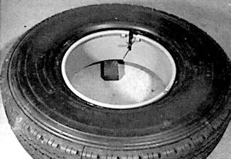Lay the rim on the floor, align the valve with the rim valve slot and work the tire onto the rim. C.