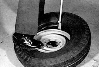 Lay the rim on the floor, align the valve with the rim valve slot and work the tire onto the rim. C.