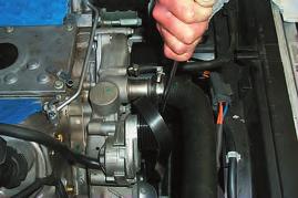 37. Remove the accessory serpentine belt by rotating the tensioner bolt with a 15mm