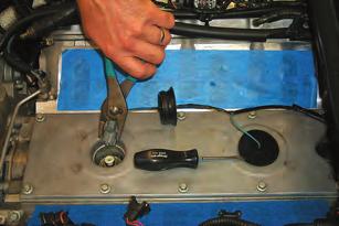 Remove the stock belt tensioner assembly by removing the two mounting bolts with a