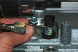 Use a small screwdriver inserted into the right side coolant barb to bend it up and out slightly at a 45 degree angle as shown.