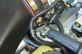 116. Connect a final length of hose to the upper barb of the heat exchanger and route it to the