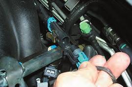 9. Remove the clamp and then the coolant line from the side of