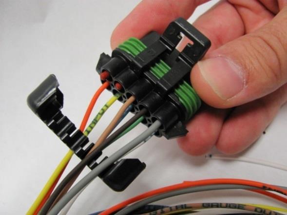 You have two options on how to properly handle these wires. The preferred option is to remove them from the connector and insert a weather proof plug in their place.