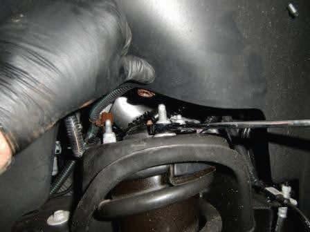 Remove the brake line bracket on the upper control arm.