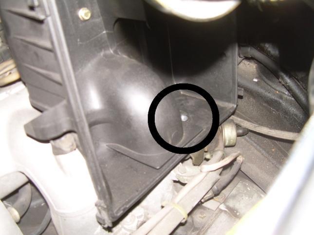 Undo the three bolts that hold the air box to