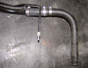 d. Install fuel filler hose onto kit extension (fuel filler) with clamp. DO NOT TIGHTEN. Fuel Filler Clamp Fuel Filler Hose e.