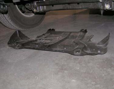 c. Remove four bolts and skid plate from front bumper and