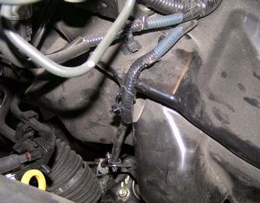 Remove or cut two ABS sensor harness clips from driver side wheel well. Clips ABS Harness b.