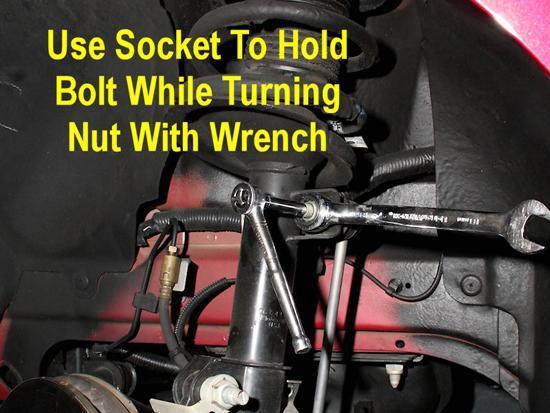 5. Use an 18mm wrench on the nut, and a 5/16 in. socket and socket wrench on the bolt.