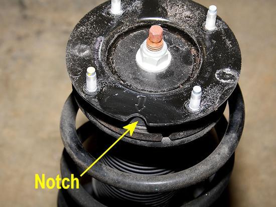 11. Once the strut is removed, you can begin working on removing the spring.