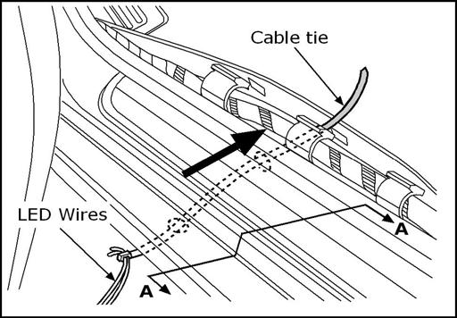 Use the cable tie to route the wires through the hole in the bottom of the vehicle and up through the access hole inside the