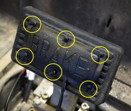 Center the LGT-138, brake light pad switch, on the lower portion of the brake pedal assembly and align it with the ridges in the