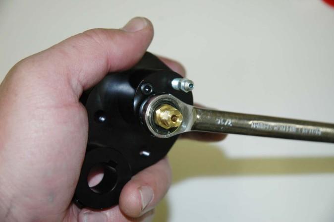 6. Install Caliper Hardware Tighten down the bleeder screw plugs into the opposite
