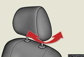 To lower : push the head restraint down while pressing the lock release button.