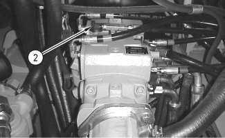 Install the 177-7861 Hose to the charge pressure tap (1) on the right side of the hydrostatic piston pump.