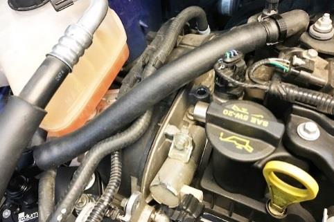 Tighten the 90 degree hose end to the catch can. Route the catch can top port hose towards the valve cover port.