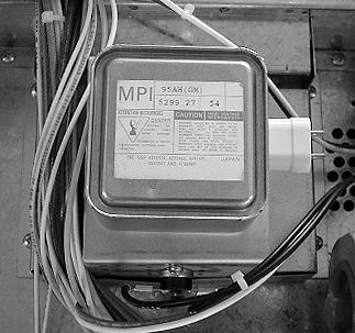 CAUTION: DISCHARGE THE HIGH VOLTAGE MICROWAVE CAPACITOR WITH A 20,000 OHM, 1- OR 2-WATT RESISTOR TO CHASSIS GROUND (SEE PAGE 18) BEFORE WORKING ON ANY OF THE HIGH VOLTAGE COM- PONENTS.