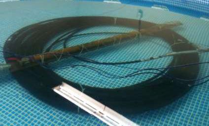 Testing in the pool required the placement of a large cast iron pipe to prevent the coil from floating to the surface.