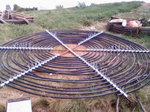 Figure 2-21. Flat-Spiral Coil 2.3.6 Slinky Coil Construction In order to construct a slinky coil from the 152.4 m (500 ft) HDPE pipe, a guide rail system and spacers were designed.