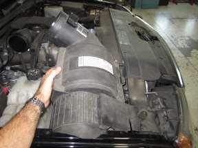 2. Removal of stock system A. Open vehicle hood. Stock intake system shown. B.