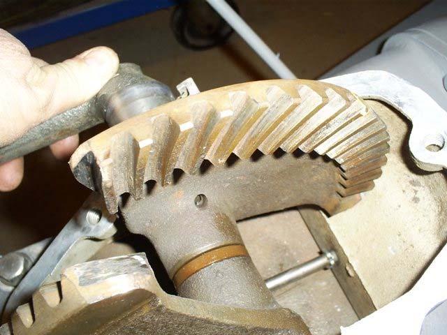 Here we see the left gear bottoming out on the lower steering casting preventing it from rotating far enough forward to disengage the pinion gear.