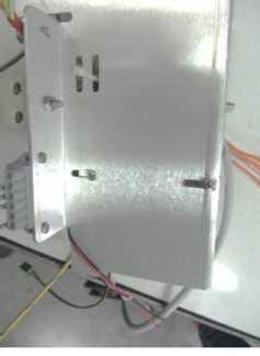 The auxiliary power supply (2) provides 1.1 amps of power for the fan and printer. The auxiliary power supply is mounted to the bottom back wall of the electronic box with two screws (4).