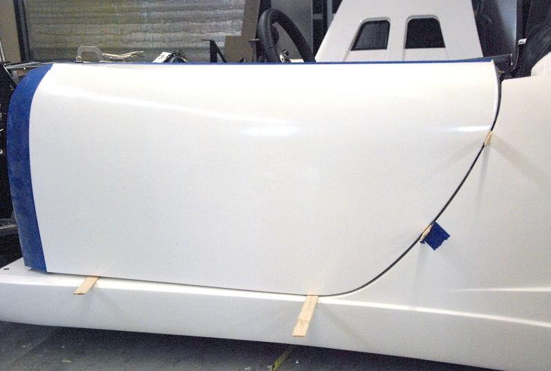 Close the door, lining up all body lines. Space the door 3 / 16 inch (paint stick thickness) from the body.