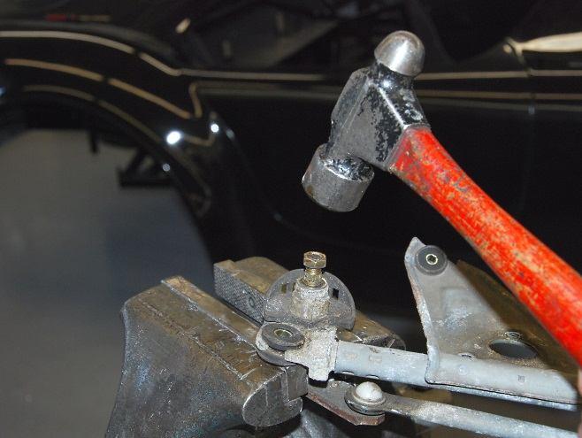 Remove the wiper arm shafts from the mount bracket.