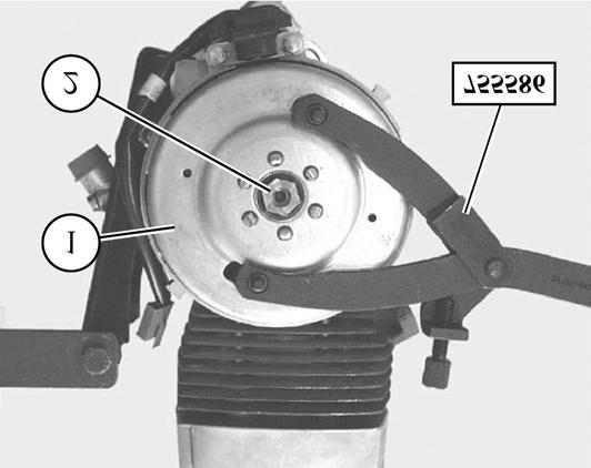 DISASSEMBLY To remove the magneto flywheel - Remove the flywheel cover - Lock the rotor (1) with tool P/N 755586 - Remove the nut (2) from the end of the