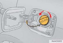 Opening the fuel tank cap 1 With the doors unlocked, press the center of the