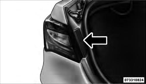 3. Grasp the tail lamp and pull firmly outward pushing on the studs from inside to disengage the lamp housing.