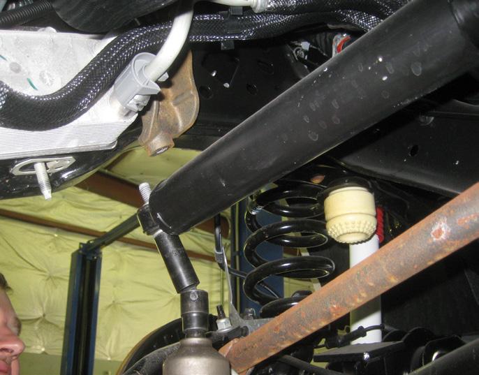 Working at the steering box, remove the cotter pin, nut