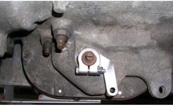 12. Take the small nut, two rubber boots and one large nut and washer off of the transmission end of the cable.