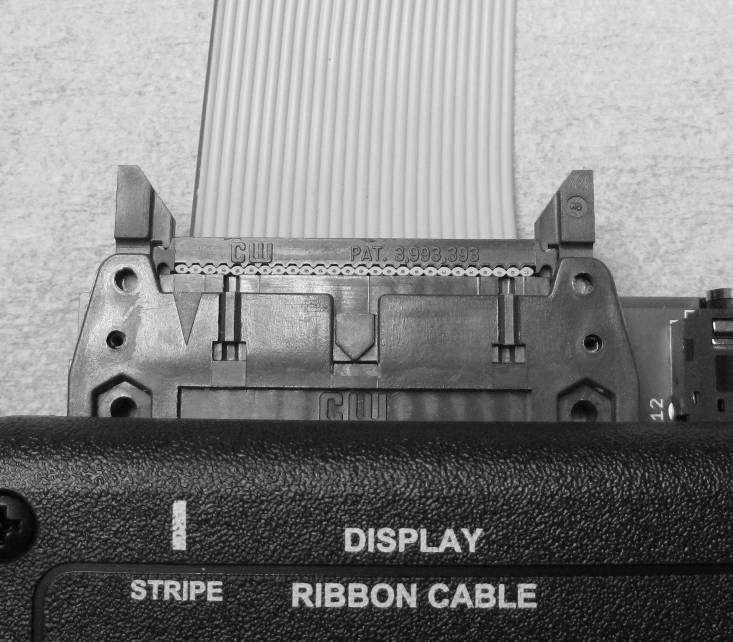 RIBBON CABLE connector. Next align the red stripe in the ribbon cable with the STRIPE text on the control box.